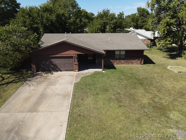 single story home with a front yard and a garage