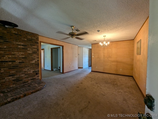 carpeted empty room with a textured ceiling and ceiling fan with notable chandelier