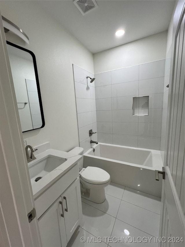 full bathroom featuring toilet, tile patterned flooring, vanity, and tiled shower / bath