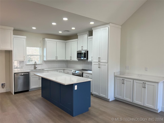 kitchen featuring white cabinetry, sink, light hardwood / wood-style floors, and appliances with stainless steel finishes