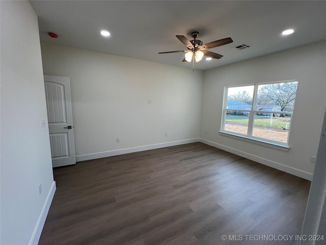 empty room with ceiling fan and dark hardwood / wood-style flooring