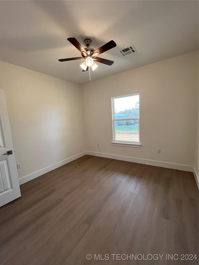 unfurnished room featuring ceiling fan and dark hardwood / wood-style flooring