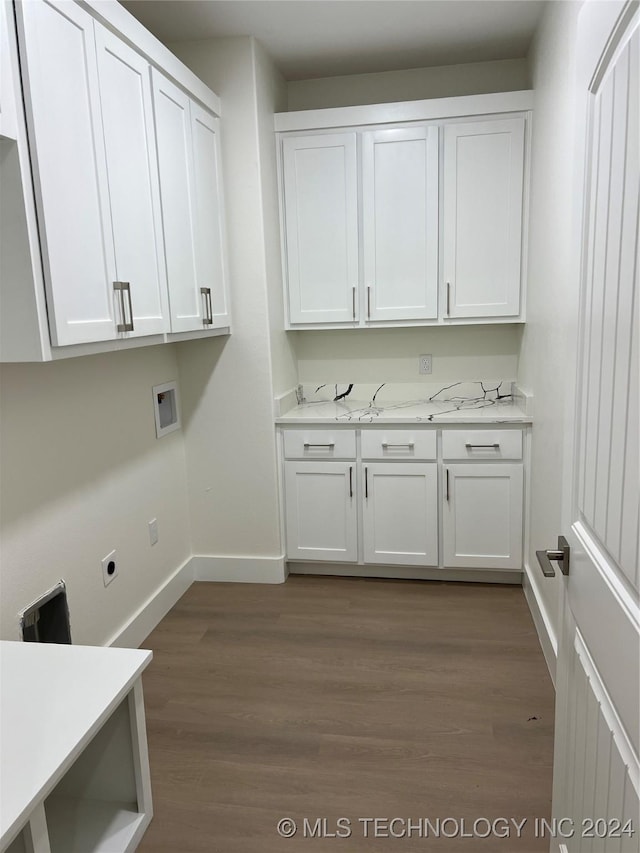 washroom with hookup for an electric dryer, dark hardwood / wood-style flooring, cabinets, and washer hookup