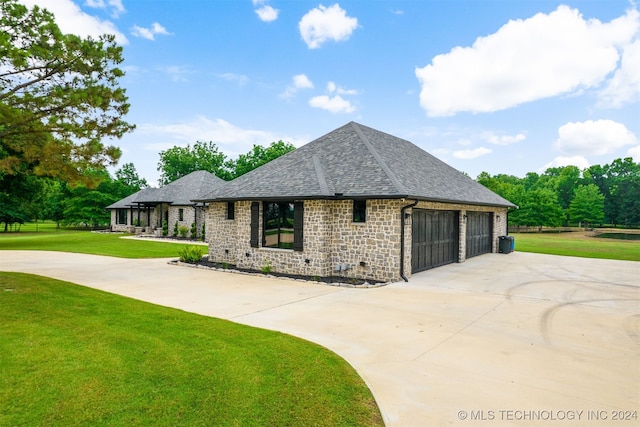 view of front of home with a front yard and a garage