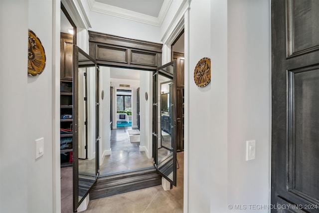 hall featuring baseboards and ornamental molding