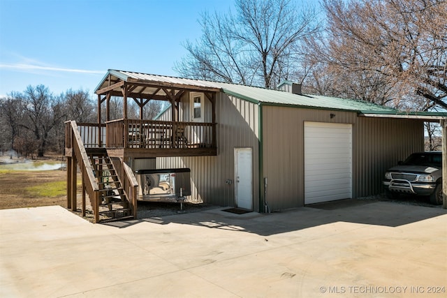 view of outbuilding featuring stairs and concrete driveway