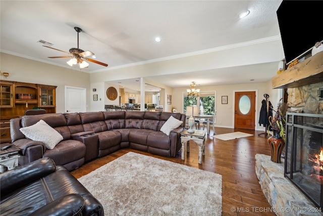 living room featuring ceiling fan with notable chandelier, dark hardwood / wood-style floors, a fireplace, and crown molding