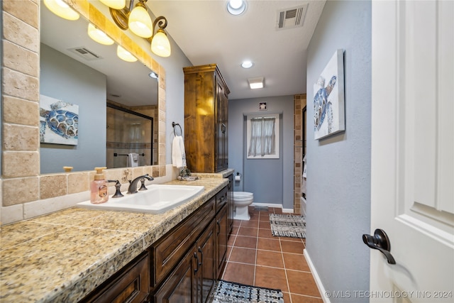 bathroom featuring tile patterned floors, curtained shower, vanity, and toilet