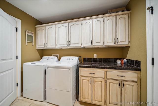 washroom featuring light tile patterned floors, independent washer and dryer, and cabinets