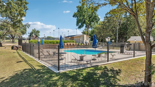 view of swimming pool with a lawn and a patio