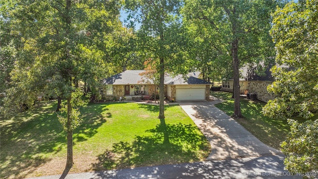 view of front of home with a front yard and a garage