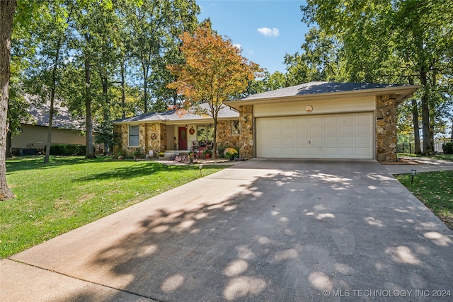 ranch-style house with a garage and a front lawn