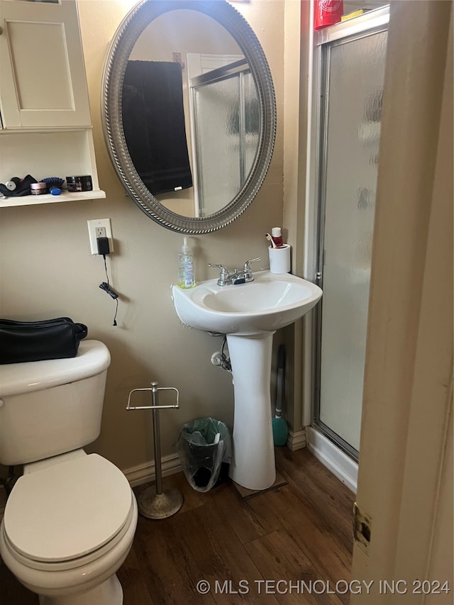 bathroom with walk in shower, hardwood / wood-style floors, and toilet