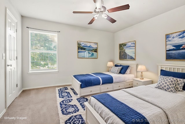 bedroom with ceiling fan and light carpet