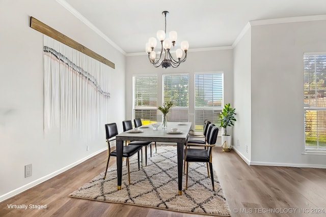 dining space with hardwood / wood-style floors, a chandelier, and crown molding