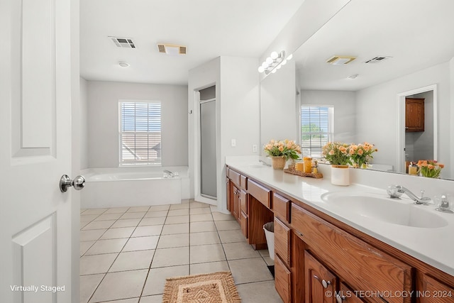 bathroom with tile patterned flooring, plenty of natural light, vanity, and shower with separate bathtub