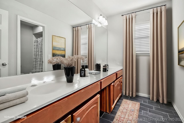 bathroom featuring a wealth of natural light and vanity