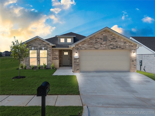 view of front of house with a garage and a lawn