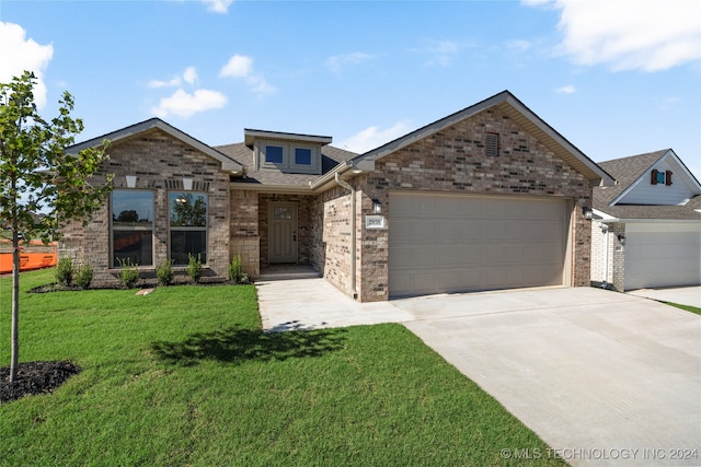 craftsman-style house with a front yard and a garage