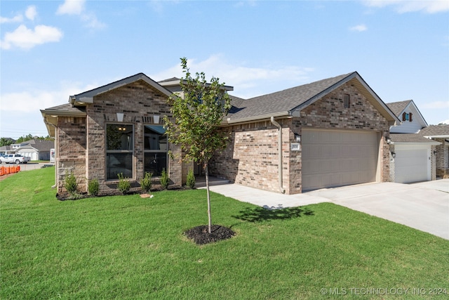 view of front of home with a front lawn and a garage