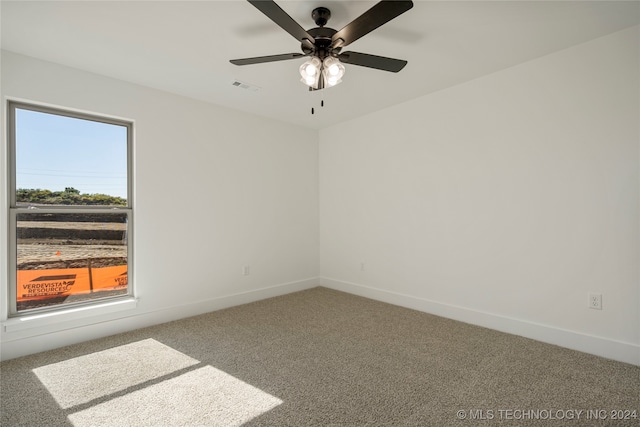 empty room featuring carpet floors and ceiling fan