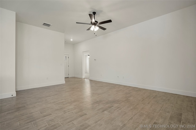 spare room with ceiling fan and light wood-type flooring