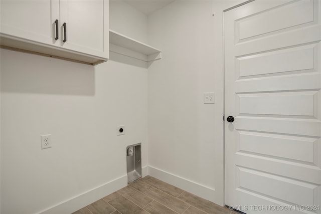 laundry room with cabinets, light hardwood / wood-style floors, and hookup for an electric dryer