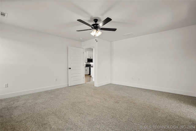 unfurnished room featuring ceiling fan and carpet floors