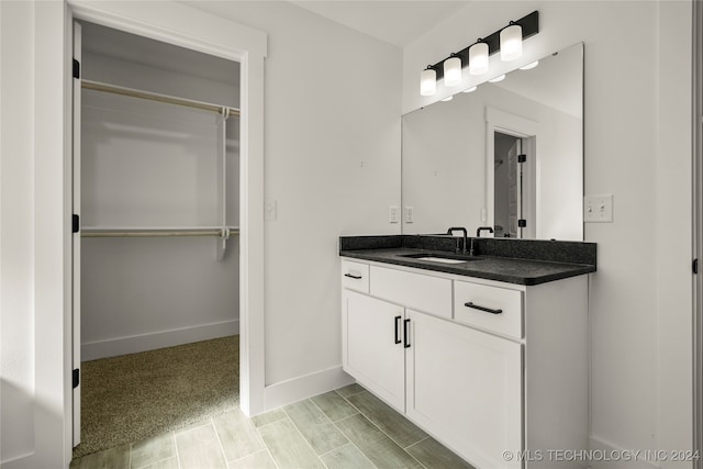 bathroom featuring hardwood / wood-style flooring and vanity