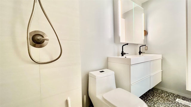 bathroom featuring vanity and toilet