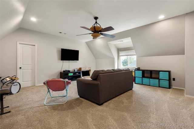 carpeted living room featuring ceiling fan and vaulted ceiling