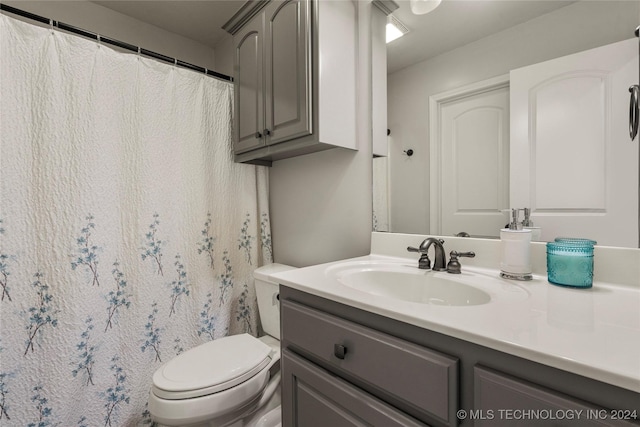 bathroom featuring toilet and vanity