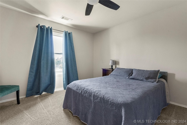 bedroom featuring light colored carpet, visible vents, ceiling fan, and baseboards