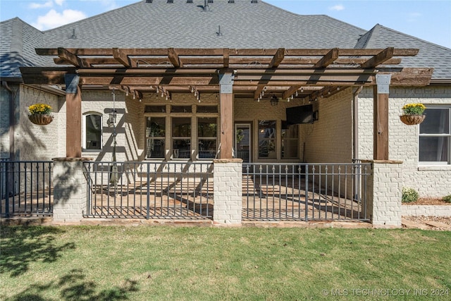 back of property featuring a shingled roof and brick siding