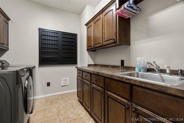 laundry area featuring separate washer and dryer, a sink, visible vents, baseboards, and cabinet space