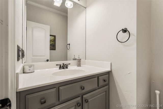 bathroom featuring ornamental molding and vanity