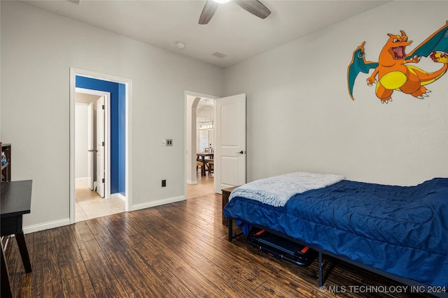 bedroom with ceiling fan and hardwood / wood-style floors