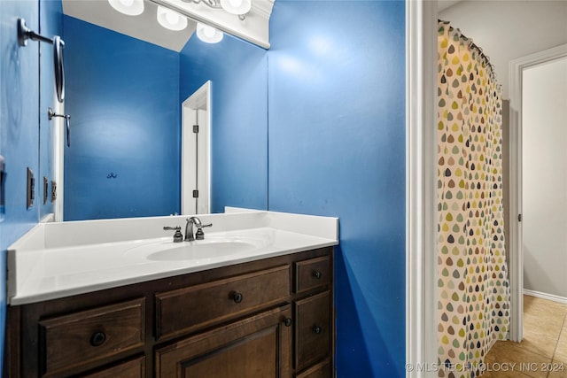 full bathroom with tile patterned floors and vanity