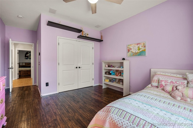 bedroom with dark hardwood / wood-style flooring, a closet, and ceiling fan