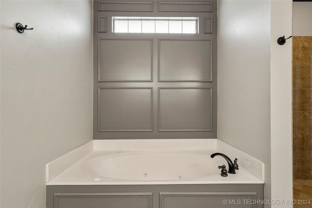 bathroom with a whirlpool tub