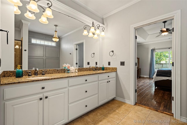 bathroom with ceiling fan with notable chandelier, tile patterned floors, a shower, vanity, and crown molding