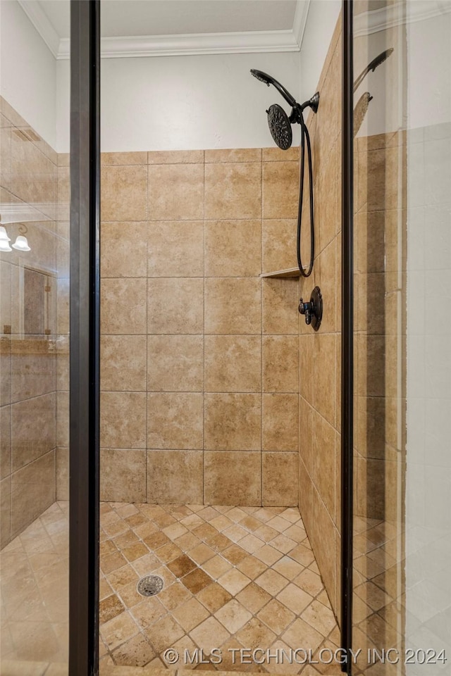 bathroom with ornamental molding and a shower with door