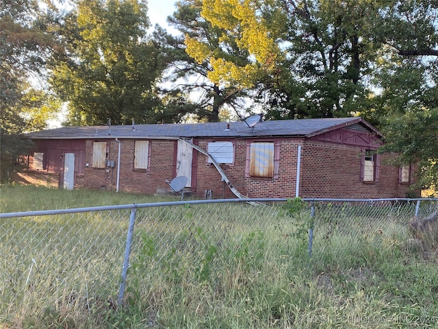 view of side of property with a lawn