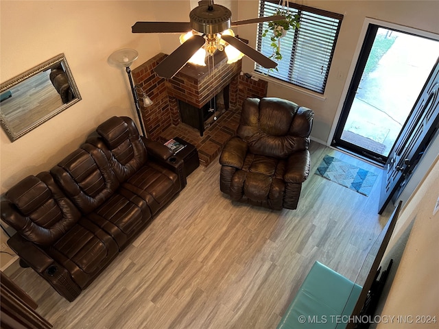 living room with light hardwood / wood-style flooring and ceiling fan