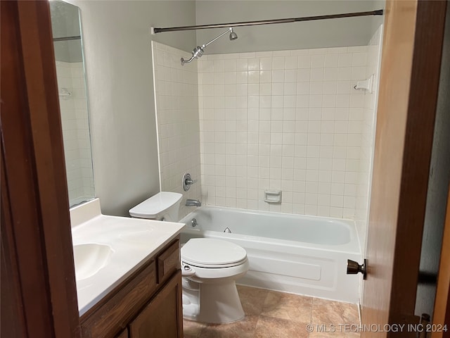 full bathroom with tiled shower / bath combo, vanity, toilet, and tile patterned floors