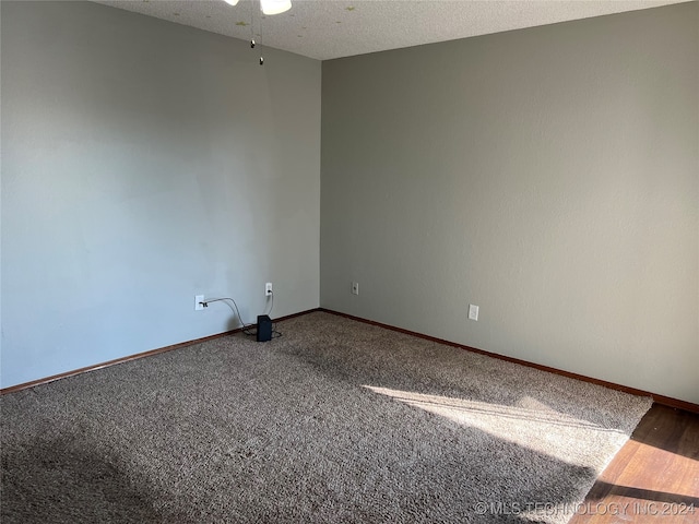 empty room featuring carpet floors, a textured ceiling, and ceiling fan