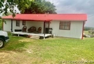 back of house featuring a yard