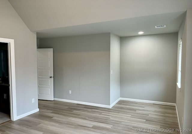 spare room featuring light hardwood / wood-style flooring