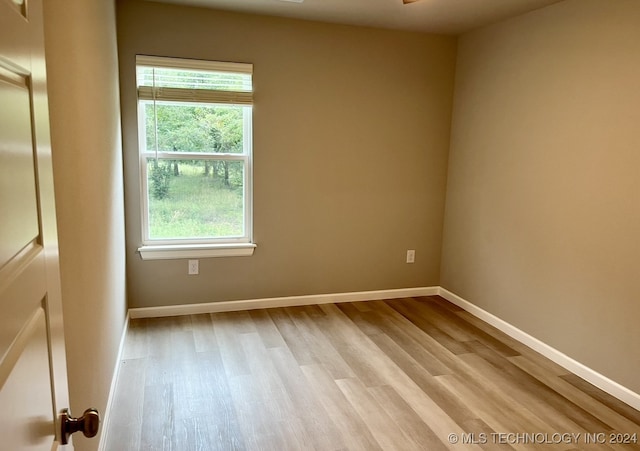 unfurnished room with light hardwood / wood-style floors