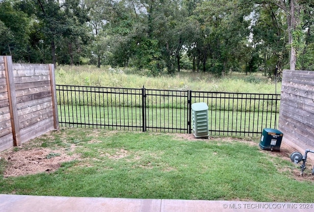 view of gate with a yard